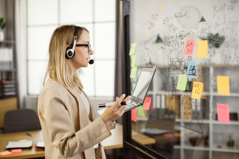 Business woman using headset and laptop for video meeting