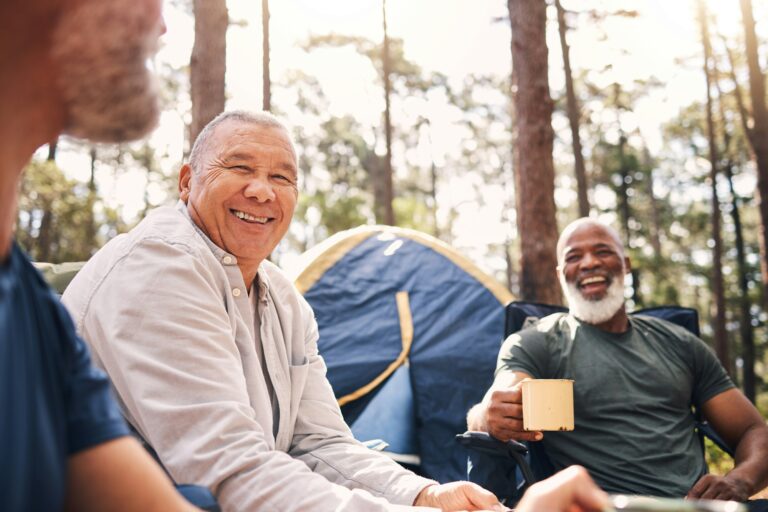 Camping, trekking and senior men in the mountains for retirement travel and bonding in Switzerland.