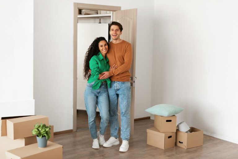 Happy man and woman posing on moving day